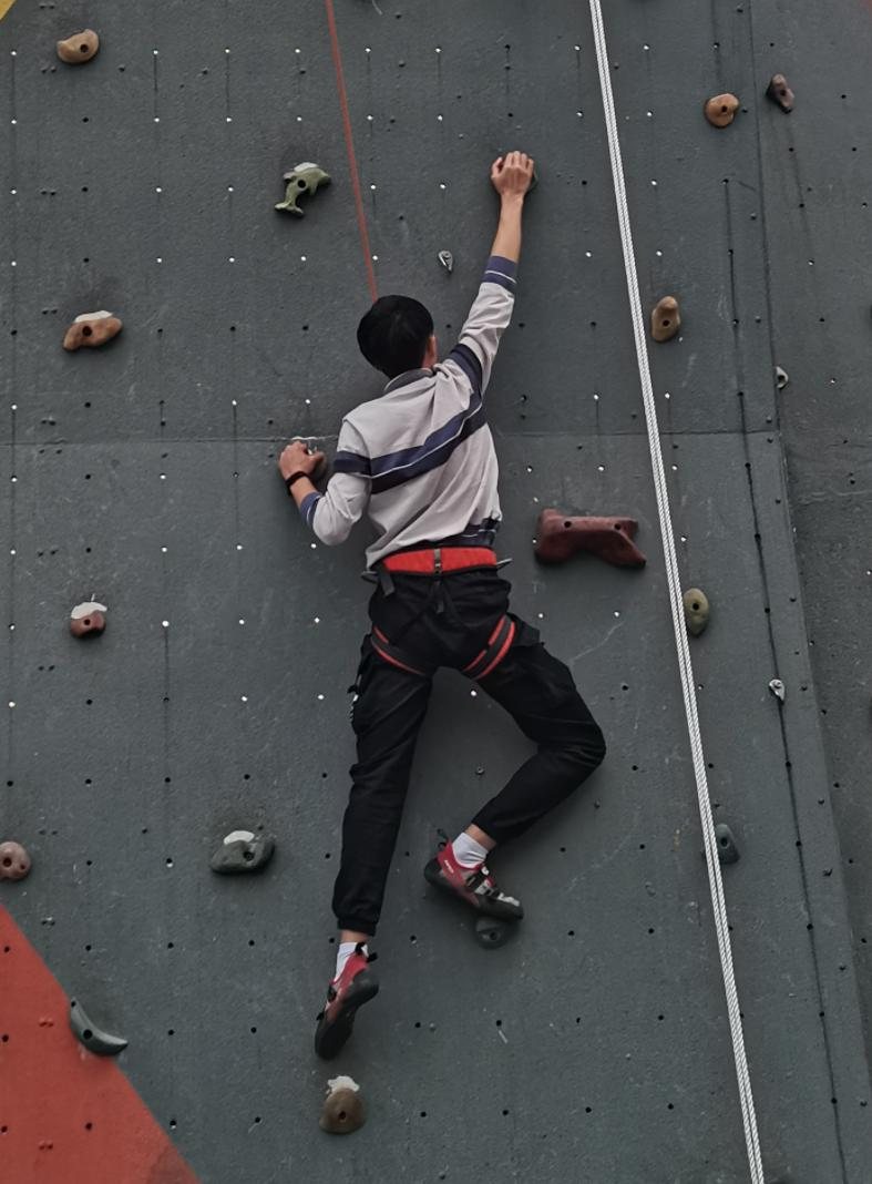 Rock climbing on an indoor wall.